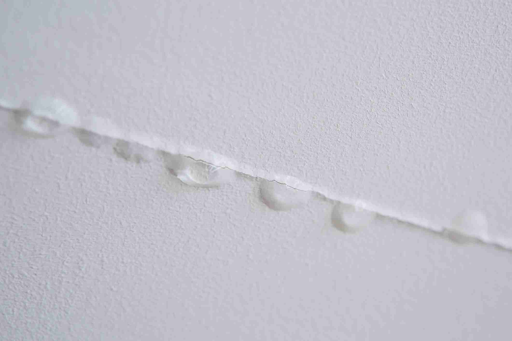 Close-up of torn paper with water droplets